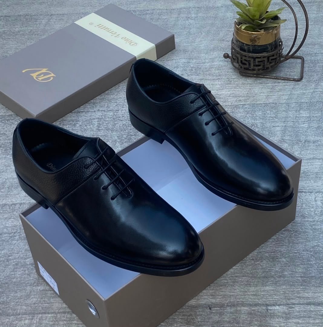root High-quality black leather oxford shoes on a shoe box, perfect for formal occasions.