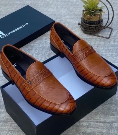 Luxurious brown leather loafers with crocodile textured detailing, presented in an open black box with the Moreschi logo, exuding high-end style and sophistication.