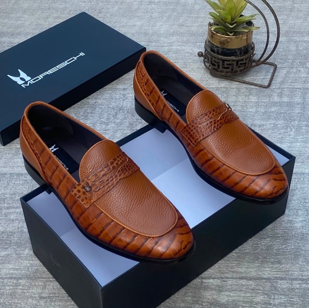 root Luxurious brown leather loafers with crocodile textured detailing, presented in an open black box with the Moreschi logo, exuding high-end style and sophistication.