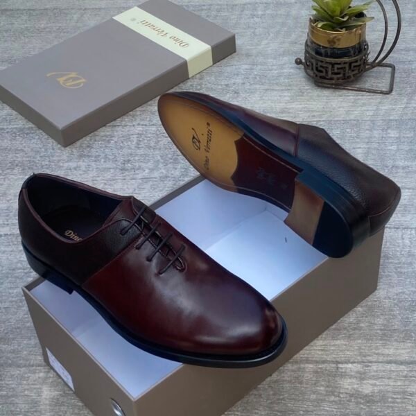 A pair of luxurious dark brown leather shoes with sleek design and elegant packaging, perfect for formal occasions.