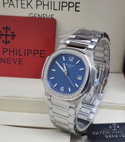 A luxurious Patek Philippe watch with a blue face and diamond-encrusted bezel, presented in an elegant box.