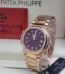 Exquisite Patek Philippe watch with a purple dial and diamond-encrusted bezel, presented in a luxurious box.