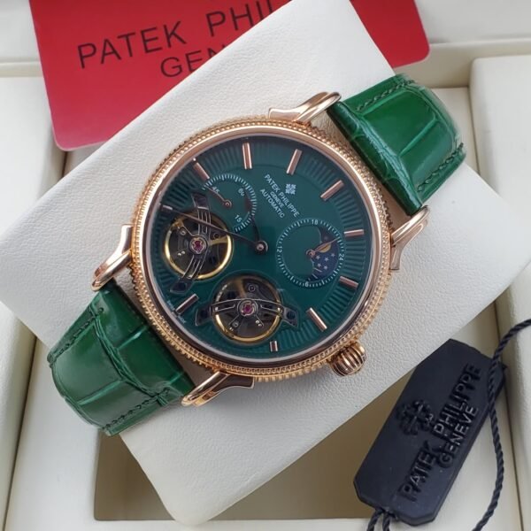 A luxurious Patek Philippe watch with a green face and leather strap, presented in a white box with a red card.
